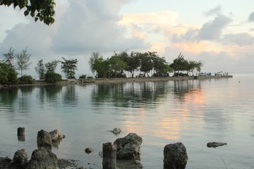 Saipan, CNMI-December 2016: Faint sunset reflected in the waters of Garapan Fishing Base in Saipan.