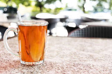 Hot ginger root tea in transparent glass good for health