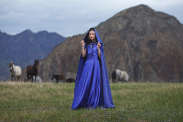 A girl walks in the mountains.