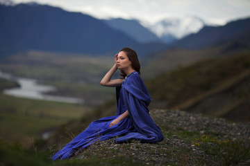 A girl walks in the mountains.