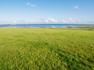 Fototapeta na wymiar Waddensea coast with marshes and harbour on Frisian island Schiermonnikoog, Netherlands