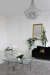 fireplace with a mirror in a gold frame in the living room of a luxury apartment