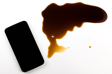Smart phone dropped, coffee spilled. isolated on white background. the concept of a damaged smartphone.