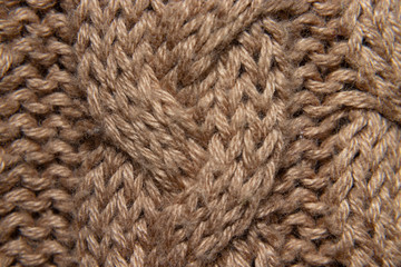 detail of embroidered wool sweater, braided in cream or camel, fabric detail