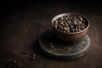 coffee beans in a cup on a brown background