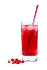 Pomegranate juice in a glass with pomegranate berries on a white isolated background