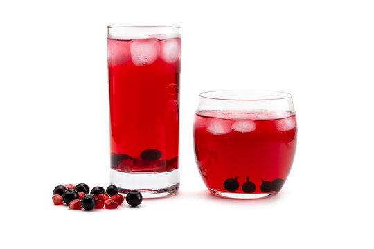 Compote pomegranate berries and blackcurrant in a glass on a white isolated background