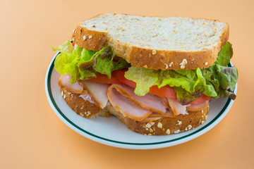 Sandwich of tomato, lettuce and smoked turkey