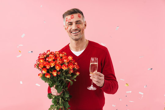 Mature man with lipstick on face holding flowers