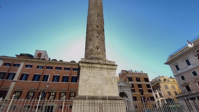 The column of Marcus Aurelius in Piazza Colonna in Rome on a sunny day.