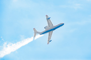 Airplane in the blue sky bottom-up view