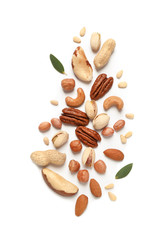 Different delicious nuts on white background, flat lay