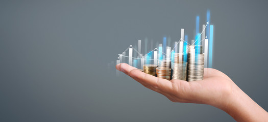 Coins stacked on each other in different positions. hand in business casual money