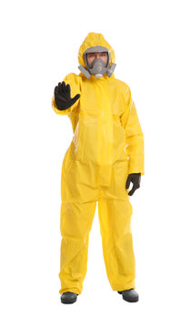 Man in chemical protective suit making stop gesture on white background. Virus research