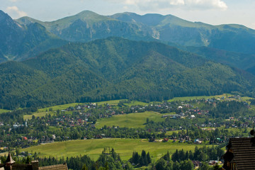Naklejka na ściany i meble Region at the foot of the Tatra Mountains. Zakopane town in Poland. Panorama of high mountains.