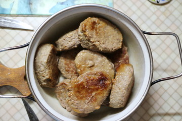 Fried meatballs in a pan on the kitchen table