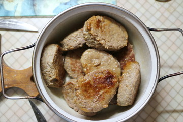 Fried meatballs in a pan on the kitchen table