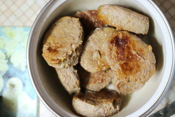 Fried meatballs in a pan on the kitchen table