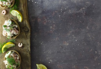 Swedish toast Skagen with shrimp, mayo and dill on rustic background. Copy space