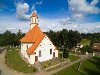 Fototapeta na wymiar Aerial view of beautiful Saint Stanislaus Kostka Church in Pozezdrze, Poland (former Possessern, East Prussia)