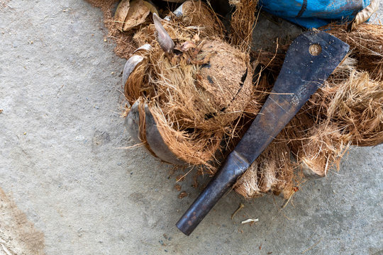 Ito knife on the pile of coconut coir in cement background are thai traditional kitchen style,countryside life in Thailand concept