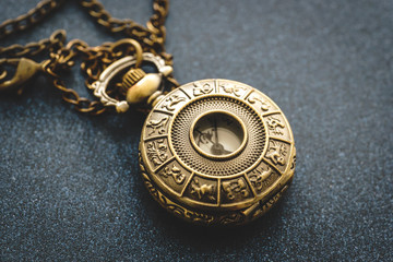 Metal pocket watch with horoscope design