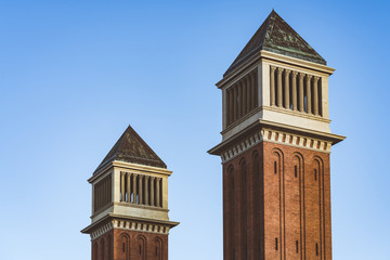 Twin Venetian towers under a blue sky