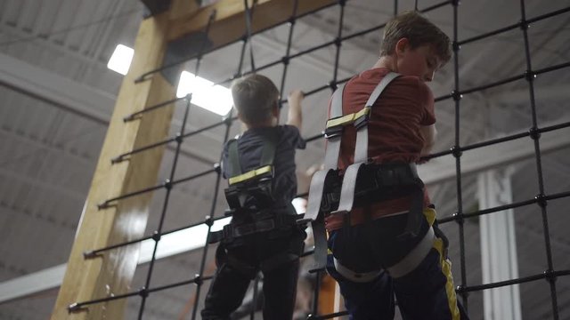 Little Boys On Indoor Climbing Course 