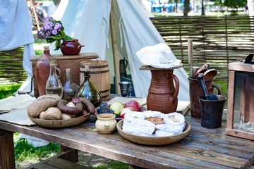 still life old bottles and and food on a wooden table