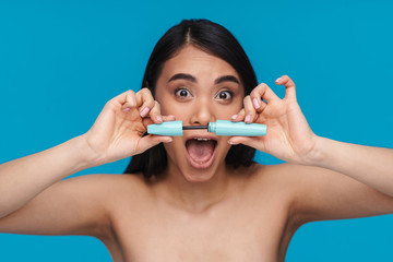 Woman posing isolated holding lash mascara.