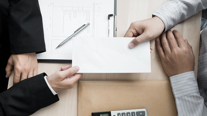 Boss received a letter of resignation from employee on the table in the office