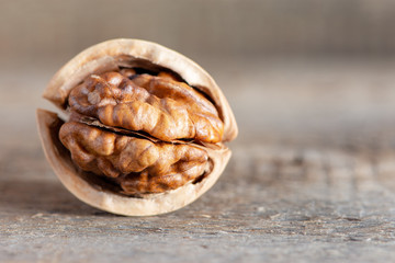 Close-up healthy chopped and unshelled walnuts on a wooden old table. Vegetarian food