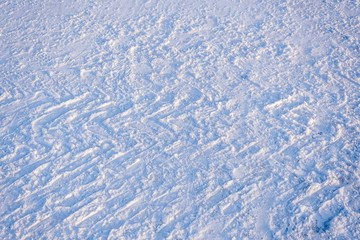 Texture. Fresh snow with traces of car treads.