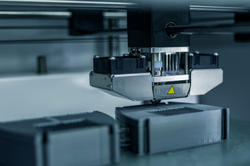 Modern technical 3D printing. Electronic three dimensional plastic printer during work.