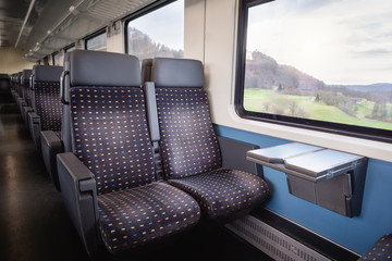 Train interior with empty seats. Swiss modern train wagon