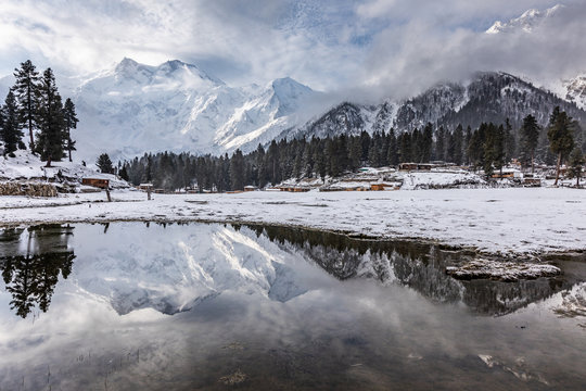 Nanga parbat mountain reflection in lake on Fairy meadows valley beautiful winter snowy landscape Karakoram Pakistan