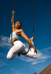 outdoors portrait of young happy and athletic Asian Indonesian woman doing aero yoga workout...