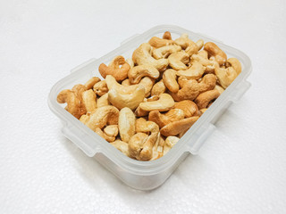 Group of Cashews in plastic box on white
