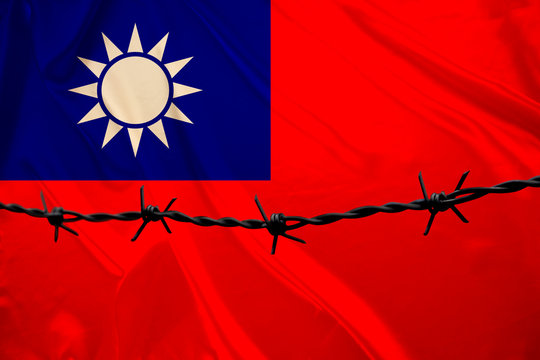 iron barbed wire against the background of the national silk flag of the Chinese Republic of Taiwan, concept imprisonment for offenders, for the siege area