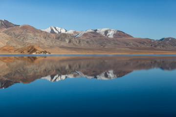 Obraz premium Mirror reflection in calm lake. morning light. Western Mongolia