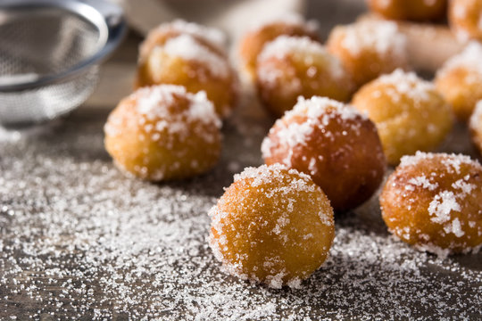 Carnival fritters or bu&ntilde;uelos de viento for holy week on wooden table	