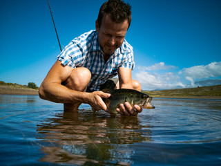 Pregnant Bass fishing on beautiful lake in South Africa closeup shot with lure