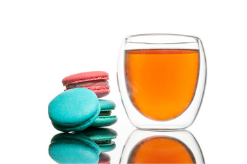 Glass cup black tea, macaroons cookies Isolated on white. Colorful and sweet French macaroons background