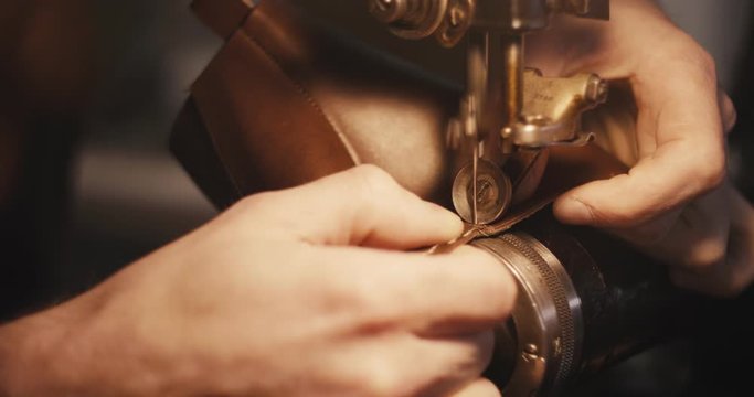 Traditional bespoke shoemaker stitching sewing leather upper old sewing machine close up