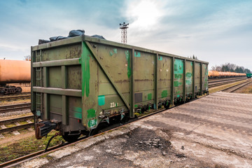 Fototapeta na wymiar Unloading bulk cargo from railway wagon