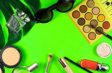 Cosmetics lies on a soft green background.