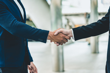 Two businessman shake hand for the first meeting. Two business people greeting outdoor.