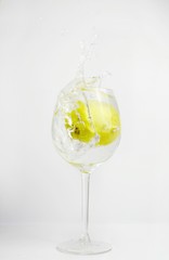 The apple fell into the glass with water 