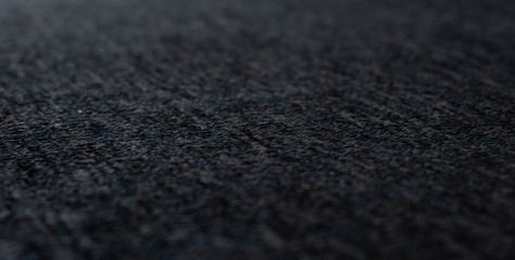 soft focus dark gray fabric textile material perspective textured background surface with blurred frame space