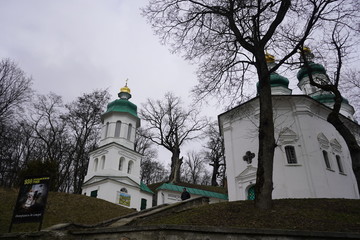 View of the domes of the church. City view, people walk around the city against the background of the church.